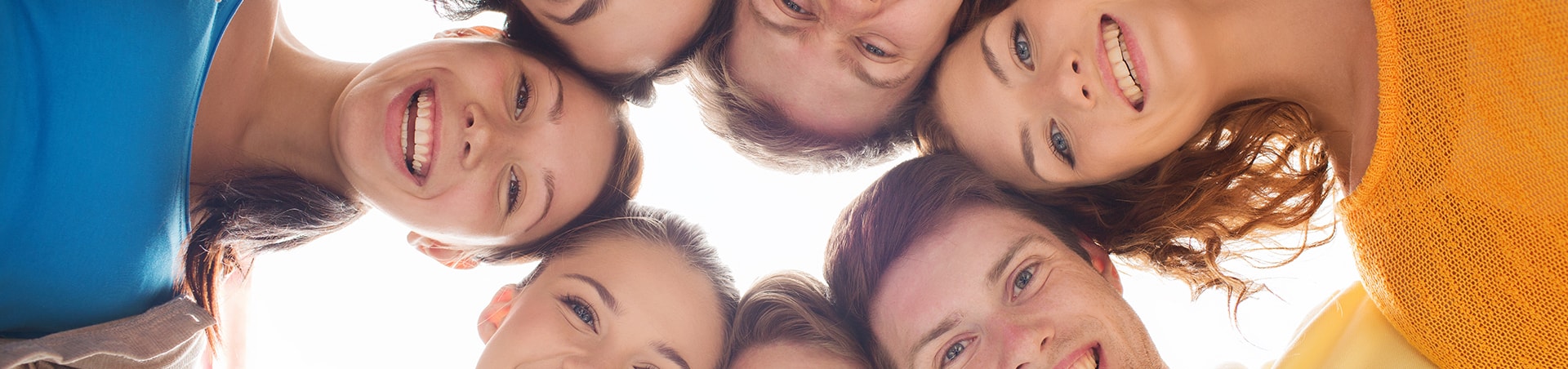 Smiling family and children huddled together